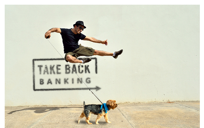 Image of man celebrating his Kasasa Cash Back checking rewards by jumping in the air next to his dog