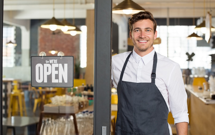 Man at store with open sign